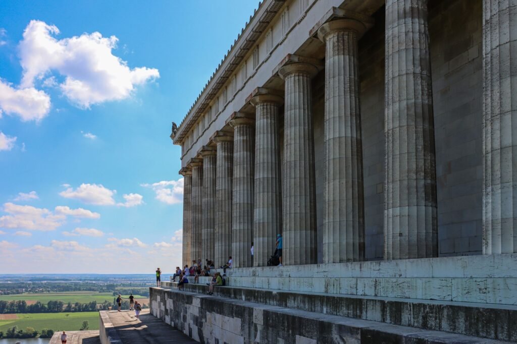 A striking view of the Walhalla memorial's grand columns under the summer sky near Regensburg, Germany.